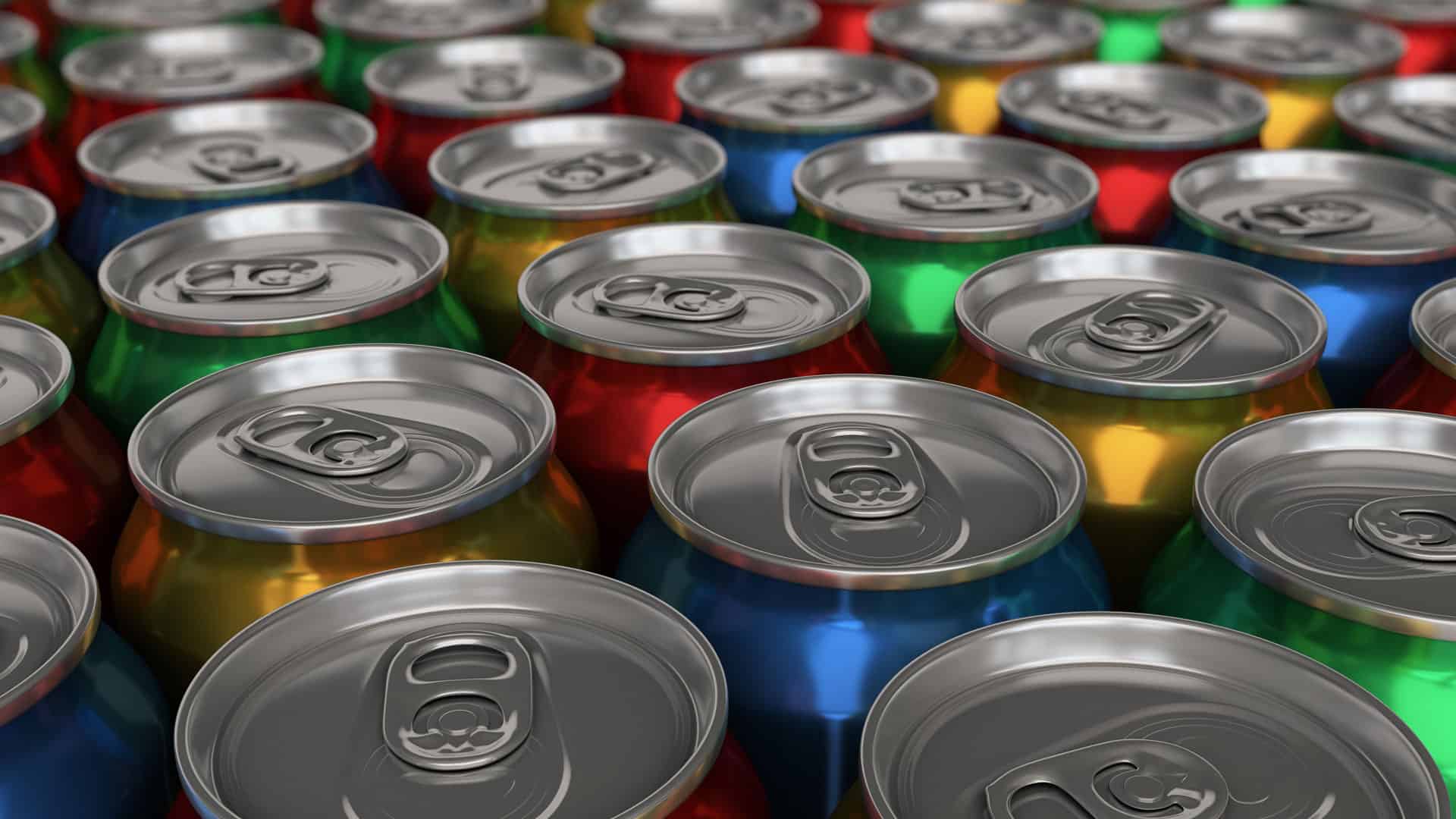 Close up view of the tops of different colored metal soda cans